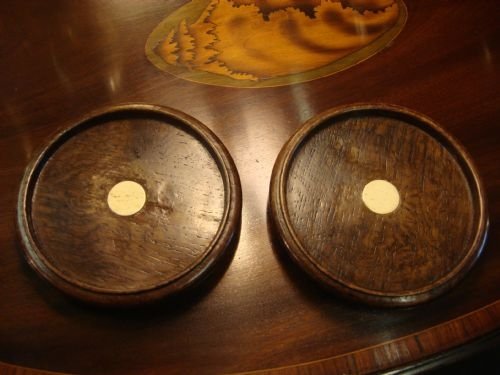 early 19th century pair of large turned oak bottle coasters with bone roundrels to centre