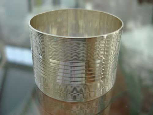 early 20th century silver plate napkin ring with all over engraved pattern