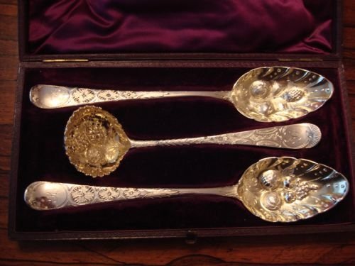 a fine george iii period solid silver set comprising a pair of berry table spoons and a sugar sifting spoon in stunning fitted case
