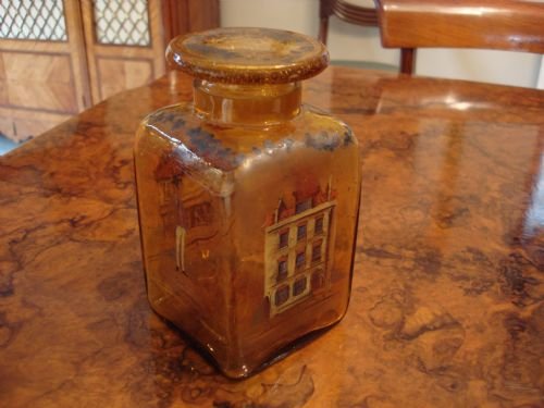 unusual amber soda glass jar with dickensian decorations