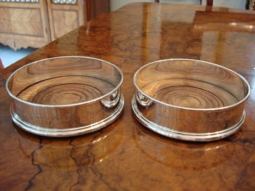 london 1975 pair of generous solid silver bottle coasters with turned wood bases