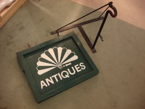 vintage early 20th century antiques shop sign with original wrought iron hanging bracket