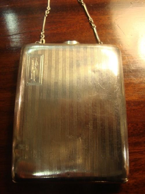 early 20th century sterling silver cigarette case with cabochon sapphire push botton closure and chain with finger ring