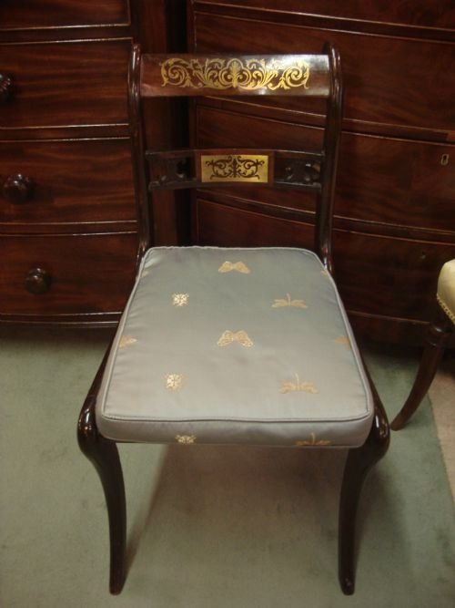 c1810 set of 4 regency sabre leg chairs with original brasses and carved back rail